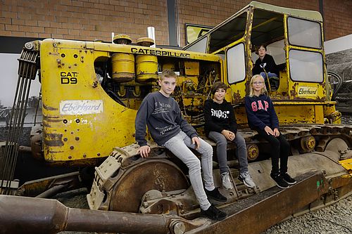 ebi.YOUNG - Die Kinder- und Jugendplattform im Bauwesen, hier auf dem Bagger im EBIANUM Museum